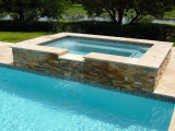 Golden white stacked stone raised spa travertine coping Carmel California