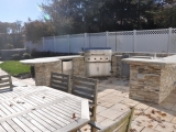 Golden Honey ledger stacked stone veneer outdoor kitchen wall